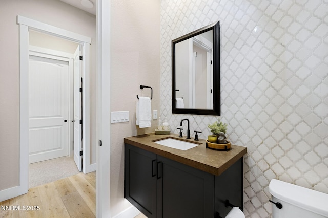 208 Criollo Ct, Reno, NV 89511 - bathroom with wood finished floors, toilet, vanity, and baseboards