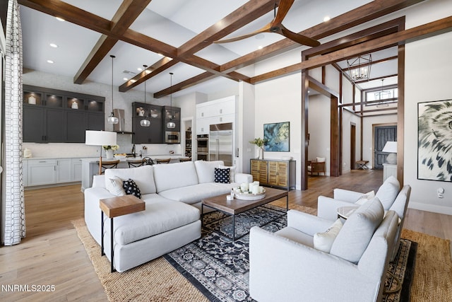 208 Criollo Ct, Reno, NV 89511 - living area featuring beam ceiling, light wood-style floors, a chandelier, a towering ceiling, and recessed lighting