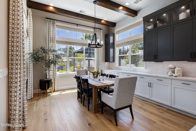 208 Criollo Ct, Reno, NV 89511 - dining area featuring light wood finished floors, a chandelier, beamed ceiling, and baseboards