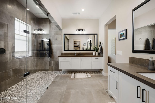 208 Criollo Ct, Reno, NV 89511 - bathroom with a shower stall, two vanities, tile patterned floors, and baseboards