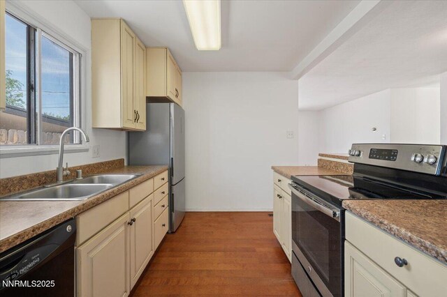 664 Beldon Way, Reno, NV 89503 - kitchen with stainless steel appliances, cream cabinetry, a sink, and wood finished floors