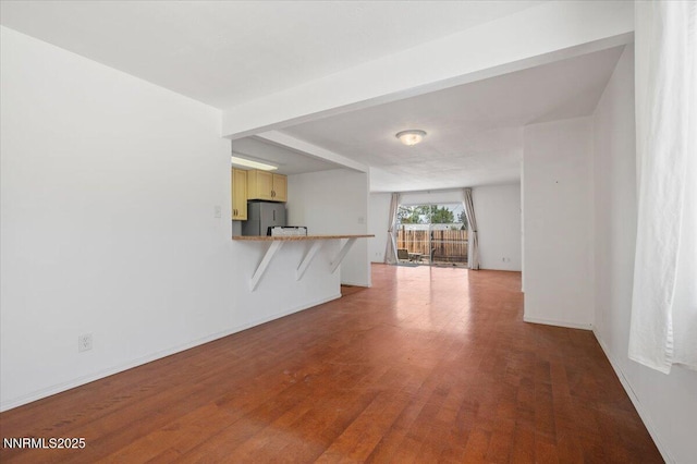 664 Beldon Way, Reno, NV 89503 - unfurnished living room featuring wood finished floors, baseboards, and beam ceiling