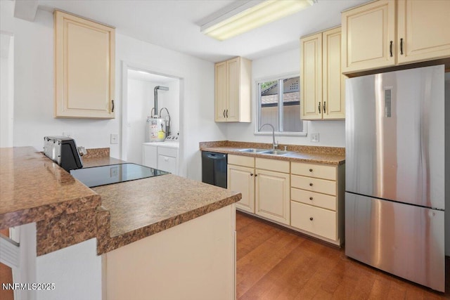 664 Beldon Way, Reno, NV 89503 - kitchen featuring freestanding refrigerator, cream cabinetry, a sink, separate washer and dryer, and dishwasher
