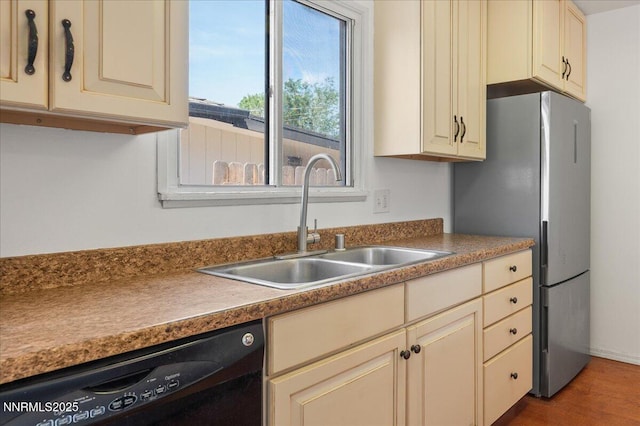 664 Beldon Way, Reno, NV 89503 - kitchen with cream cabinets, black dishwasher, a sink, and freestanding refrigerator