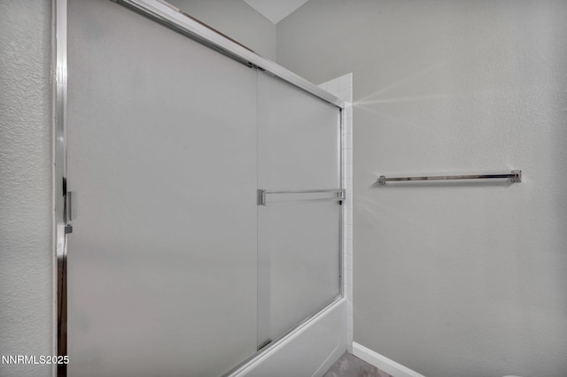 9951 Grand Falls Dr, Reno, NV 89506 - bathroom featuring combined bath / shower with glass door and baseboards