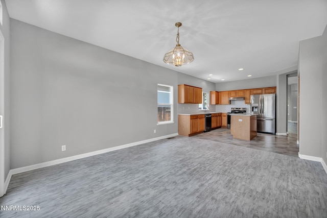 9951 Grand Falls Dr, Reno, NV 89506 - kitchen with appliances with stainless steel finishes, open floor plan, a chandelier, light wood-type flooring, and baseboards