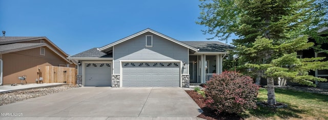 9951 Grand Falls Dr, Reno, NV 89506 - ranch-style house featuring an attached garage, concrete driveway, and stone siding