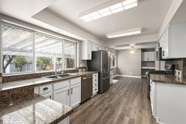 15 Sunlit Ct, Sparks, NV 89441 - kitchen featuring stainless steel appliances, a sink, tile countertops, dark wood-style floors, and baseboards