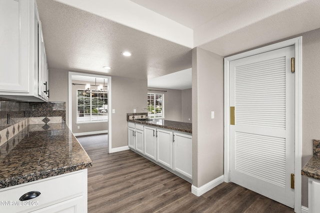 15 Sunlit Ct, Sparks, NV 89441 - kitchen with baseboards, dark wood-style floors, decorative backsplash, white cabinets, and recessed lighting