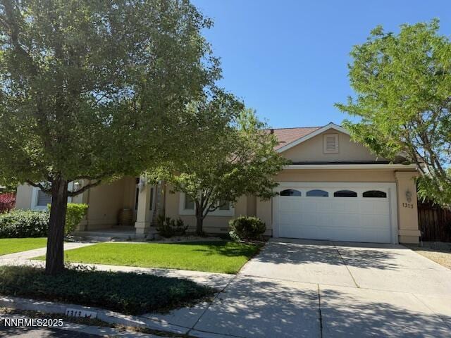 1313 Cedar Creek Cir, Gardnerville, NV 89460 - obstructed view of property with an attached garage, driveway, stucco siding, and a front lawn