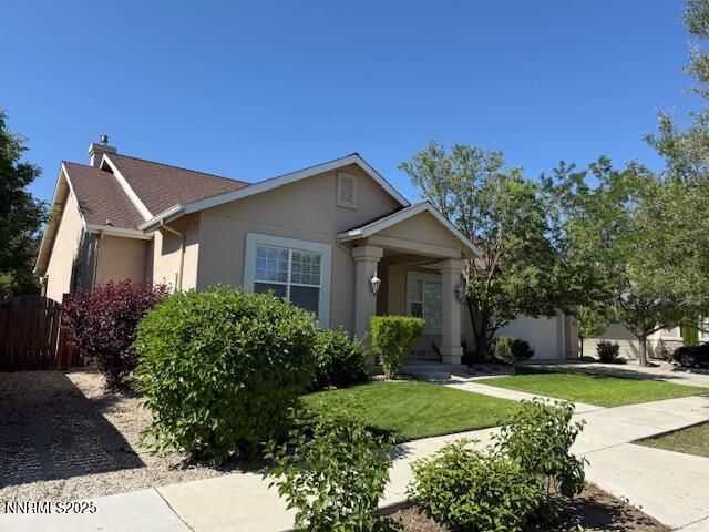 1313 Cedar Creek Cir, Gardnerville, NV 89460 - ranch-style home with stucco siding, a chimney, and a front yard