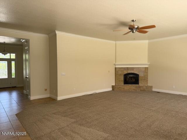 1313 Cedar Creek Cir, Gardnerville, NV 89460 - unfurnished living room with crown molding, a ceiling fan, a tile fireplace, and tile patterned floors