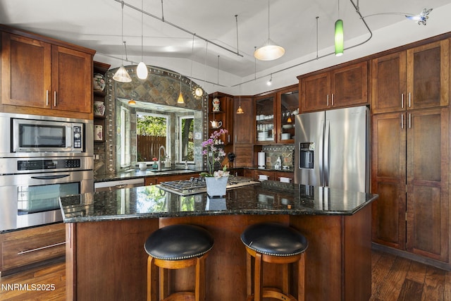 13450 Evening Song Ln, Reno, NV 89511 - kitchen with appliances with stainless steel finishes, open shelves, vaulted ceiling, a sink, and a center island