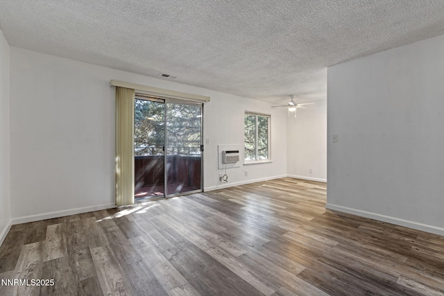 4608 Neil Rd Unit 226, Reno, NV 89502 - spare room featuring wood finished floors, a textured ceiling, ceiling fan, a wall mounted AC, and baseboards