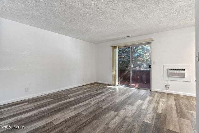 4608 Neil Rd Unit 226, Reno, NV 89502 - unfurnished room with wood finished floors, a wall mounted air conditioner, a textured ceiling, and baseboards