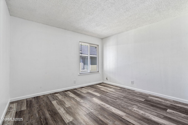 4608 Neil Rd Unit 226, Reno, NV 89502 - empty room with dark wood-style flooring, a textured ceiling, and baseboards