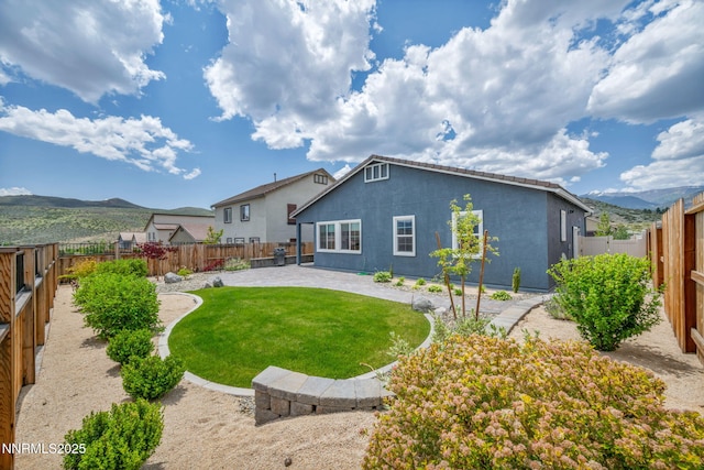 14206 Tuscan Sun Ct, Reno, NV 89511 - back of house with a patio, stucco siding, a mountain view, and a fenced backyard