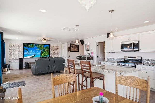 1318 Serenity Cir, Fernley, NV 89408 - dining area featuring light wood-style floors, recessed lighting, and ceiling fan