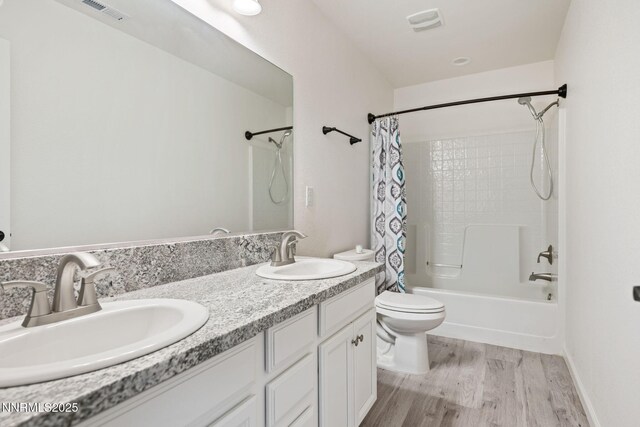 1318 Serenity Cir, Fernley, NV 89408 - full bathroom featuring toilet, shower / bathtub combination with curtain, double vanity, and wood finished floors