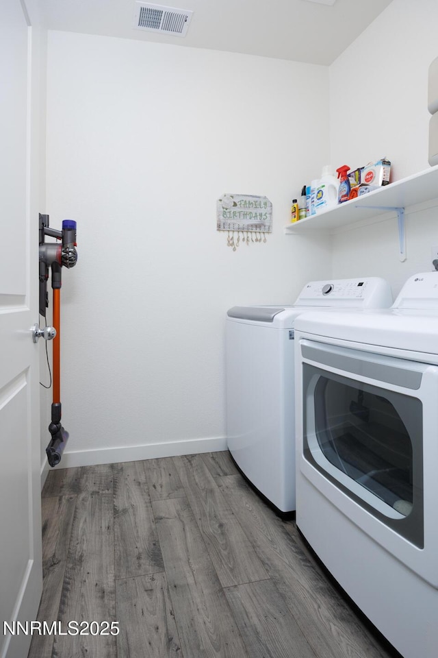 703 Sycamore Dr, Fallon, NV 89406 - washroom with washing machine and clothes dryer, wood finished floors, and baseboards