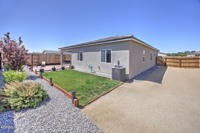 703 Sycamore Dr, Fallon, NV 89406 - rear view of property with central AC unit, a patio, and stucco siding
