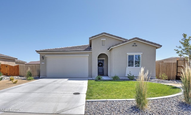 703 Sycamore Dr, Fallon, NV 89406 - mediterranean / spanish home featuring a garage, driveway, stucco siding, and a tile roof