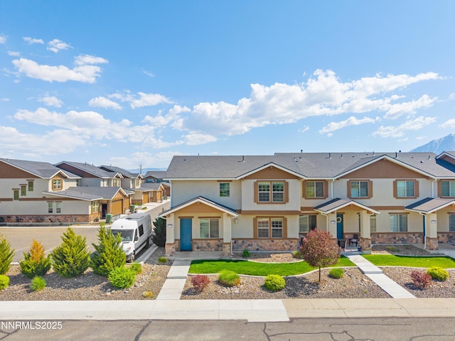 1170 Montevideo Cir, Minden, NV 89423 - townhome / multi-family property with stucco siding, a residential view, and stone siding