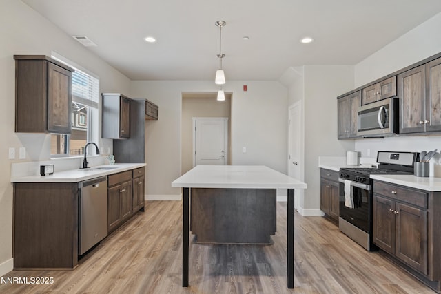 1170 Montevideo Cir, Minden, NV 89423 - kitchen featuring appliances with stainless steel finishes, a sink, dark brown cabinets, baseboards, and recessed lighting