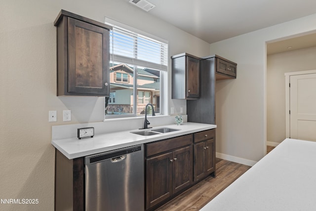 1170 Montevideo Cir, Minden, NV 89423 - kitchen with stainless steel dishwasher, a sink, dark brown cabinets, and wood finished floors
