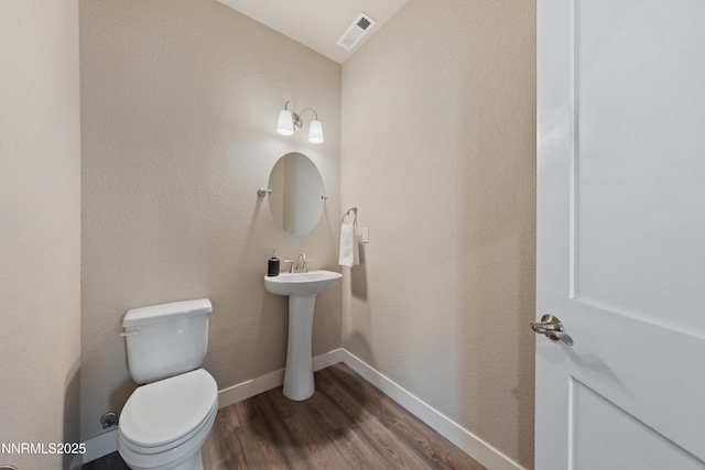 1170 Montevideo Cir, Minden, NV 89423 - bathroom featuring wood finished floors, toilet, a sink, and baseboards