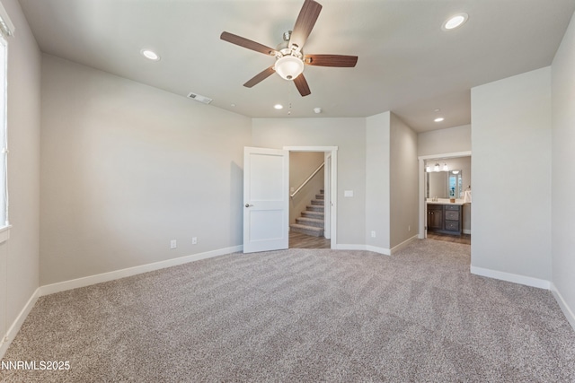 1170 Montevideo Cir, Minden, NV 89423 - unfurnished bedroom with light colored carpet, recessed lighting, ensuite bath, baseboards, and ceiling fan