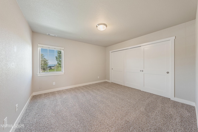 1170 Montevideo Cir, Minden, NV 89423 - unfurnished bedroom with carpet flooring, baseboards, a closet, and a textured ceiling