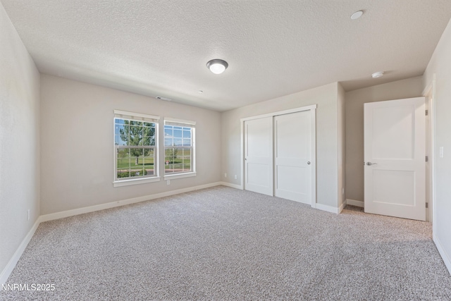 1170 Montevideo Cir, Minden, NV 89423 - unfurnished bedroom with baseboards, carpet floors, a textured ceiling, and a closet