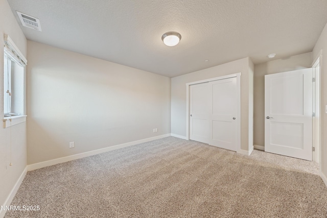 1170 Montevideo Cir, Minden, NV 89423 - unfurnished bedroom with carpet floors, baseboards, a textured ceiling, and a closet
