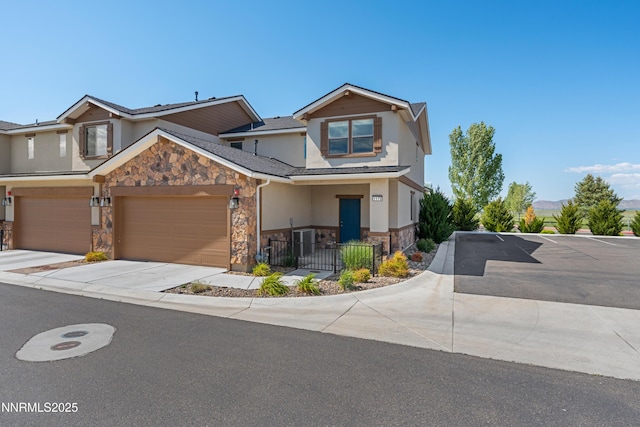 1170 Montevideo Cir, Minden, NV 89423 - view of front facade with stone siding, stucco siding, concrete driveway, and an attached garage