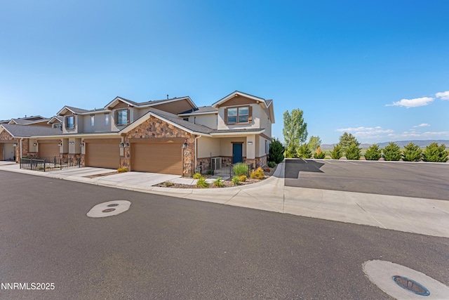 1170 Montevideo Cir, Minden, NV 89423 - view of front of property with stone siding, an attached garage, and driveway