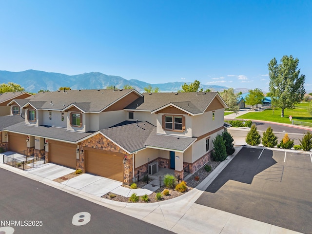 1170 Montevideo Cir, Minden, NV 89423 - view of front of house with stone siding, a mountain view, stucco siding, driveway, and a garage
