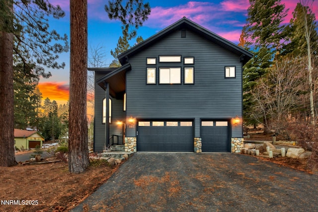 997 Dorcey Dr, Incline Village, NV 89451 - view of front facade featuring driveway, a garage, and stone siding