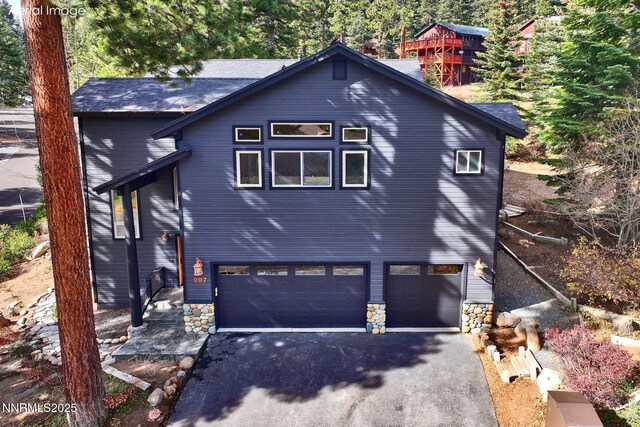 997 Dorcey Dr, Incline Village, NV 89451 - view of front of house with driveway, a garage, and stone siding
