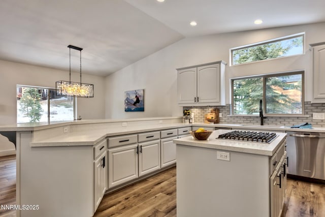 997 Dorcey Dr, Incline Village, NV 89451 - kitchen featuring appliances with stainless steel finishes, a sink, a center island, a peninsula, and vaulted ceiling