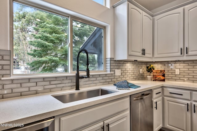 997 Dorcey Dr, Incline Village, NV 89451 - kitchen with stainless steel dishwasher, a sink, backsplash, white cabinetry, and dishwashing machine
