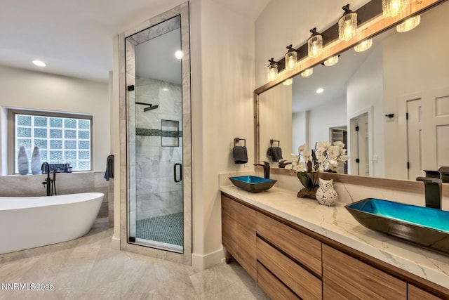 997 Dorcey Dr, Incline Village, NV 89451 - bathroom with double vanity, a shower stall, a soaking tub, marble finish flooring, and recessed lighting