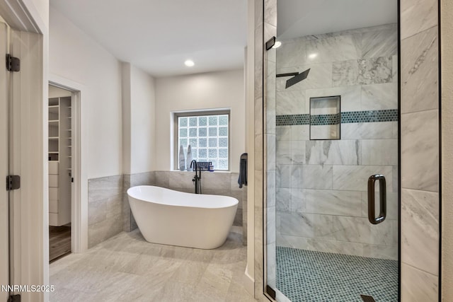 997 Dorcey Dr, Incline Village, NV 89451 - bathroom with a shower stall, tile walls, a freestanding bath, marble finish floors, and a spacious closet