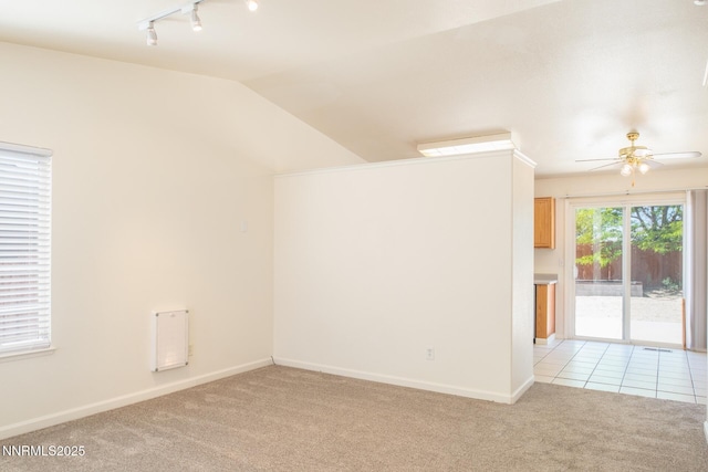 7344 Rubens Ct, Sun Valley, NV 89433 - spare room with a ceiling fan, rail lighting, light carpet, vaulted ceiling, and baseboards