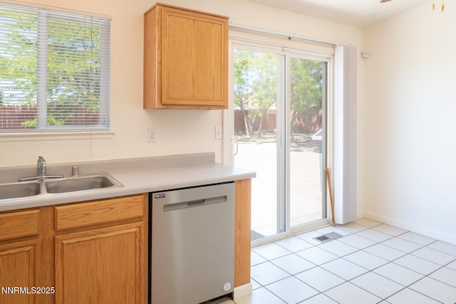 7344 Rubens Ct, Sun Valley, NV 89433 - kitchen featuring stainless steel dishwasher, a sink, light countertops, and light tile patterned floors