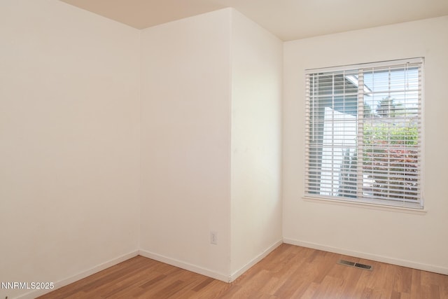 7344 Rubens Ct, Sun Valley, NV 89433 - spare room featuring light wood finished floors, baseboards, and healthy amount of natural light