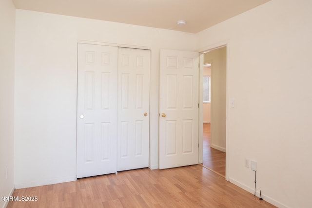 7344 Rubens Ct, Sun Valley, NV 89433 - unfurnished bedroom with light wood-style flooring, a closet, and baseboards