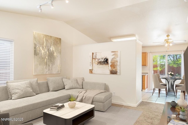 7344 Rubens Ct, Sun Valley, NV 89433 - living room with track lighting, a ceiling fan, lofted ceiling, light colored carpet, and baseboards