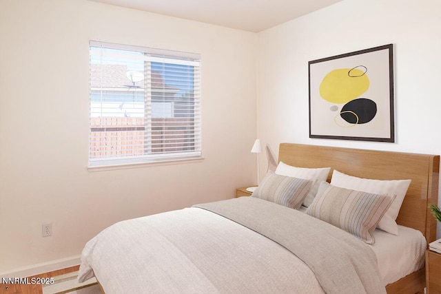 7344 Rubens Ct, Sun Valley, NV 89433 - bedroom with baseboards and wood finished floors