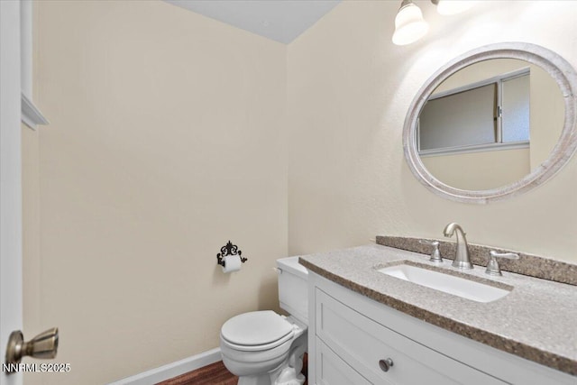 2731 Wabash Cir, Sparks, NV 89434 - bathroom with toilet, vanity, baseboards, and wood finished floors
